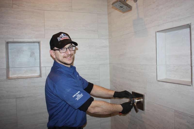 Plumbing technician installing shower valve
